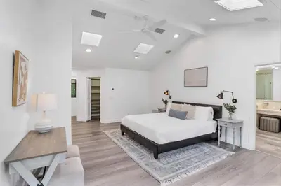 a white bedroom with a bed and a table at Fallbrook Pool & Spa Wine Country Estate in Fallbrook
