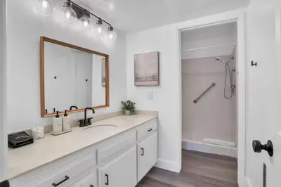 a white bathroom with a sink and a mirror at Fallbrook Pool & Spa Wine Country Estate in Fallbrook