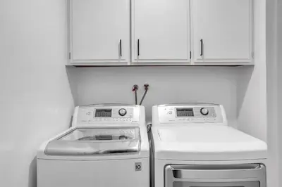 a kitchen with two machines and white cabinets at Fallbrook Pool & Spa Wine Country Estate in Fallbrook