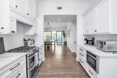 a kitchen with white appliances and a dining room at Fallbrook Pool & Spa Wine Country Estate in Fallbrook