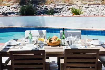 a table with bottles and glasses and a bowl of food at Palm Grove Luxe King, Wet Room & Chefs Kitchen in Carlsbad