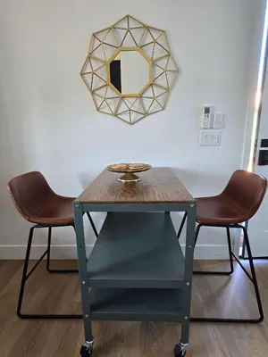 a table with two chairs and a mirror on the wall at Private Studio - Stylish Cozy & Central in San Diego