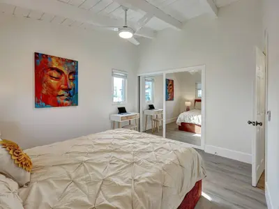a bedroom with a bed and a painting on the wall at Seaglass 222 in San Clemente