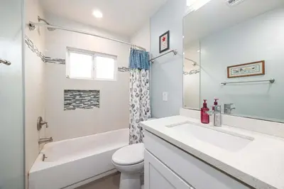 a white bathroom with a sink and a toilet at Pool Oasis Central Villa in El Cajon