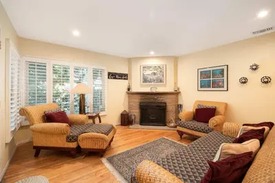 a living room with two couches and a fireplace at Pool Oasis Central Villa in El Cajon