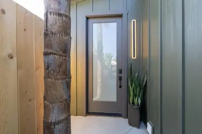 a hallway with a door and a potted plant at Newly Remodeled OB Beach house walk to all Parking in San Diego