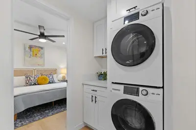 a laundry room with a washer and dryer at Newly Remodeled OB Beach house walk to all Parking in San Diego