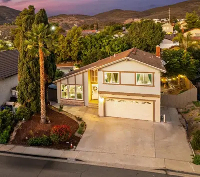 a house with a garage and a palm tree at Entire Private Home with 4 Bedrooms 2 Bathrooms Garage, Pool, King Bed, Gated Yard in Rancho Penasquitos, Available Now in San Diego