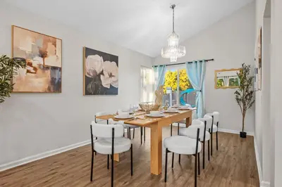 a dining room with a table and chairs at Entire Private Home with 4 Bedrooms 2 Bathrooms Garage, Pool, King Bed, Gated Yard in Rancho Penasquitos, Available Now in San Diego