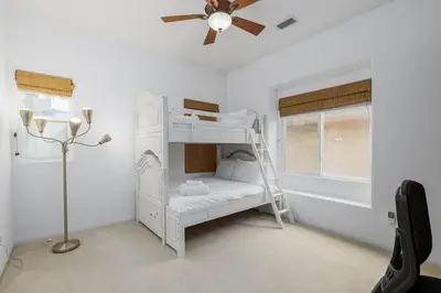 a white bunk bed in a room with a ceiling fan at Ocean View 4 Bedroom Home in Carlsbad