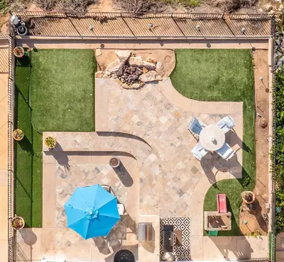 an overhead view of a patio with a blue umbrella at Ocean View 4 Bedroom Home in Carlsbad