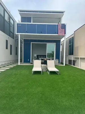 a house with two chairs and an american flag at Luxurious Beach Master Suite in San Diego