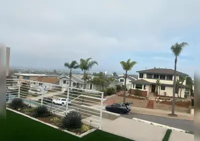 a house with a car parked in a parking lot at Luxurious Beach Master Suite in San Diego