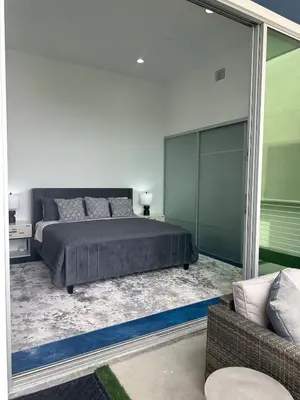 a bedroom with a bed and a sliding glass door at Luxurious Beach Master Suite in San Diego