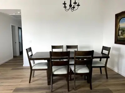 a dining room table with four chairs and a chandelier at Harbor View Haven by Balboa Park in San Diego