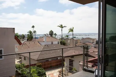 a view of the city from the balcony of a house at Harbor View Haven by Balboa Park in San Diego