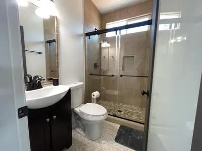 a bathroom with a toilet and a sink and a shower at Harbor View Haven by Balboa Park in San Diego