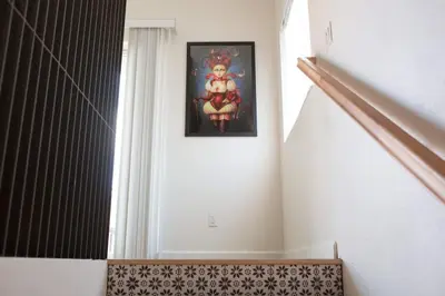 a hallway with a picture of a woman on the wall at Harbor View Haven by Balboa Park in San Diego