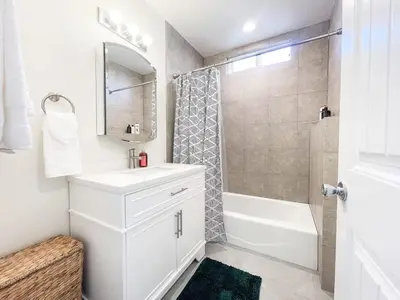a white bathroom with a sink and a shower at Central Charm in Hillcrest near Scripps Mercy in San Diego