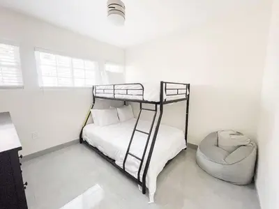 a bedroom with a bunk bed and a chair at Central Charm in Hillcrest near Scripps Mercy in San Diego