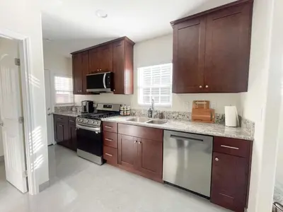 a kitchen with wooden cabinets and a stove top oven at Central Charm in Hillcrest near Scripps Mercy in San Diego