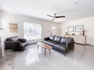 a living room with a leather couch and a table at Central Charm in Hillcrest near Scripps Mercy in San Diego