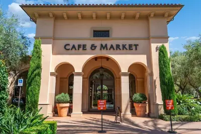 a building with the entrance to a cafe and market at Elegant New 2BR Luxury Home in Irvine in Lake Forest