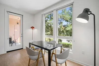 a dining room with a table and chairs and a window at Elegant New 2BR Luxury Home in Irvine in Lake Forest