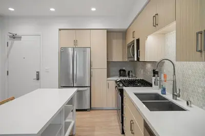 a kitchen with a stainless steel refrigerator and cabinets at Elegant New 2BR Luxury Home in Irvine in Lake Forest