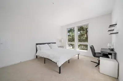 a white bedroom with a bed and a desk at Elegant New 2BR Luxury Home in Irvine in Lake Forest