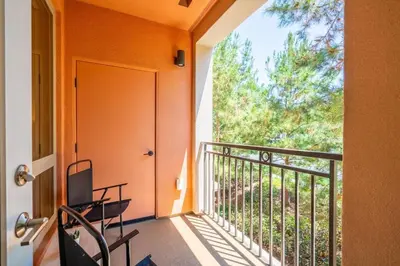 a balcony with a door and a table and chairs at Elegant New 2BR Luxury Home in Irvine in Lake Forest