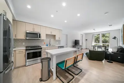 a kitchen and living room with a stove top oven at Elegant New 2BR Luxury Home in Irvine in Lake Forest