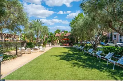 a park with lawn chairs and tables and trees at Elegant New 2BR Luxury Home in Irvine in Lake Forest