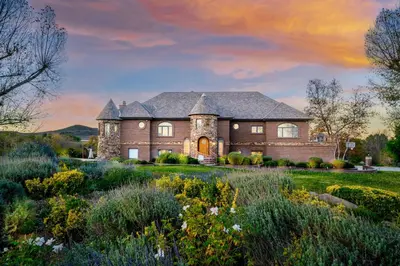 a large brick house with a landscaping at Indoor Pool & Spa - Gym - Sauna - Pickleball Court in Perris