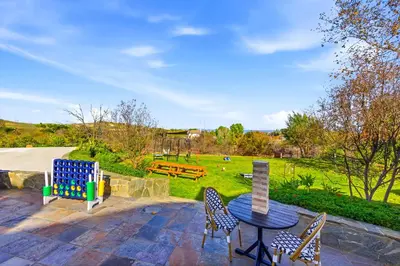 a patio with a table and chairs and a park at Indoor Pool & Spa - Gym - Sauna - Pickleball Court in Perris