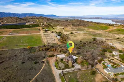a yellow and green hot air balloon flying over a house at Indoor Pool & Spa - Gym - Sauna - Pickleball Court in Perris