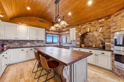 a kitchen with white cabinets and a wooden ceiling at Indoor Pool & Spa - Gym - Sauna - Pickleball Court in Perris