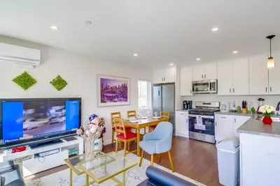 a kitchen with white cabinets and a tv and a table at Entire Private Home with 3 Bedrooms 3 Bathrooms, Near San Diego Downtown & Beach, Available Now in National City