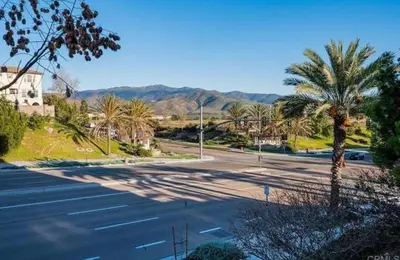 a street with a palm tree on the side of a road at Beautiful Spacious Condo in an Excellent Location in Chula Vista