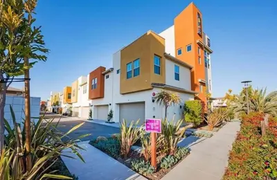 a house with a sign in front of it at Beautiful Spacious Condo in an Excellent Location in Chula Vista