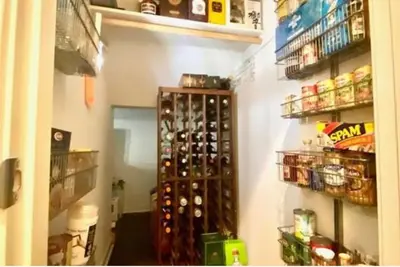 a room with a bunch of wine bottles on a wall at Beautiful Spacious Condo in an Excellent Location in Chula Vista