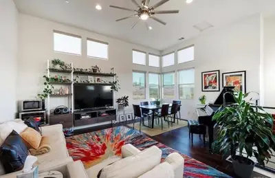 a living room with a couch and a tv at Beautiful Spacious Condo in an Excellent Location in Chula Vista