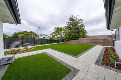 a backyard with a lawn and a fence at Amazing Pool Side View of SeaWorld & the Ocean in San Diego