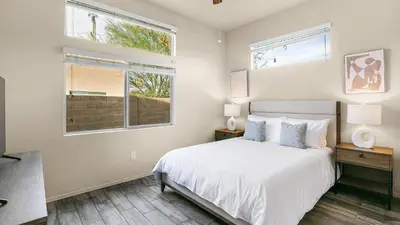 a white bedroom with a bed and a window at Landing Stylish 1BD Yoga Studio Game Room in Murrieta