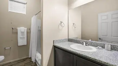 a bathroom with a sink and a toilet and a shower at Landing Stylish 1BD Yoga Studio Game Room in Murrieta