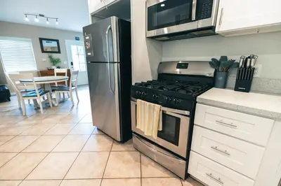 a kitchen with a stainless steel refrigerator and a stove at Mission Casa Del Sol in San Diego