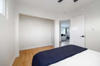 a white bedroom with a bed and a sliding door at Spacious & Newly Renovated Villa in San Diego - Perfect for Families in San Diego