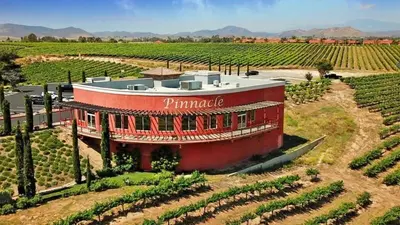 a red building in the middle of a vineyard at Your Home Away From Home near Wineries & Old Town in Murrieta