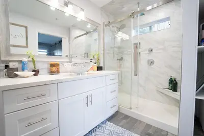 a white bathroom with a shower and a sink at LOVE SHACK on private canyon, minutes to the Beach in San Diego