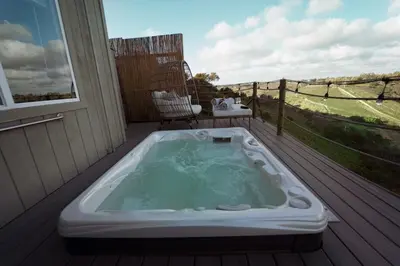 a hot tub sitting on a deck on a porch at LOVE SHACK on private canyon, minutes to the Beach in San Diego